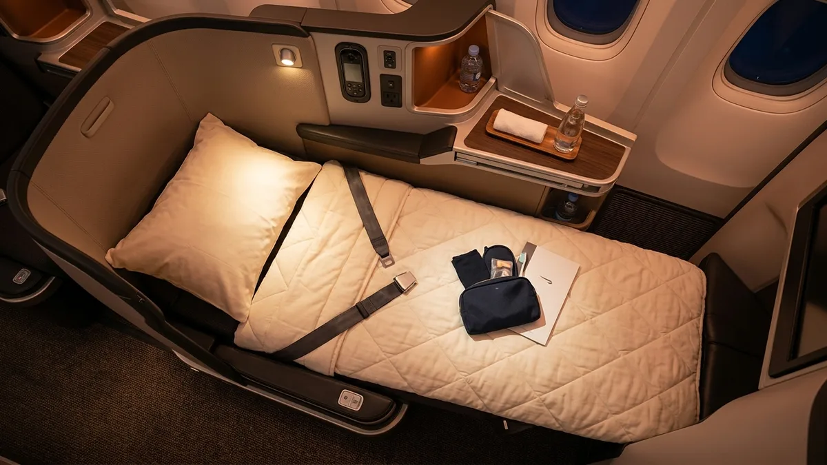 Business class lie-flat seat prepared for sleep