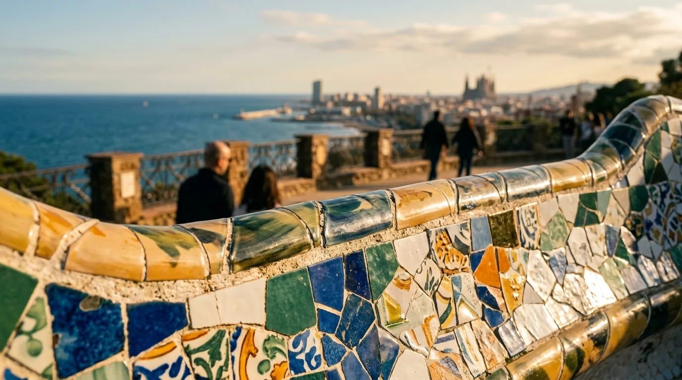 Gaudí mosaic detail at Park Güell with Barcelona skyline